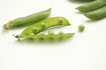 Healthy food concept. Green pea pods clouse up on white background.