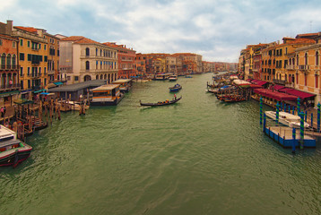 Venice, Italy-September 28, 2019: Wide angle landscape view of famous Grand Canal with many different boats and ancient colorful buildings. Autumn morning
