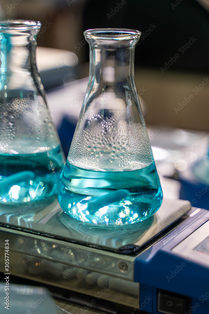 Poster testing blue solution in glass flask