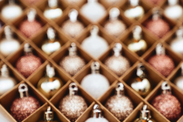Blurred Golden Christmas baubles decoration in box . Holiday concept.