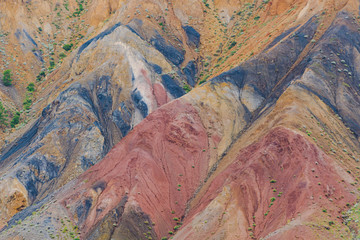 Colored hills, stripes of different colors on slope of canyon. Dry land due to lack of water. Drought in desert. Soil erosion