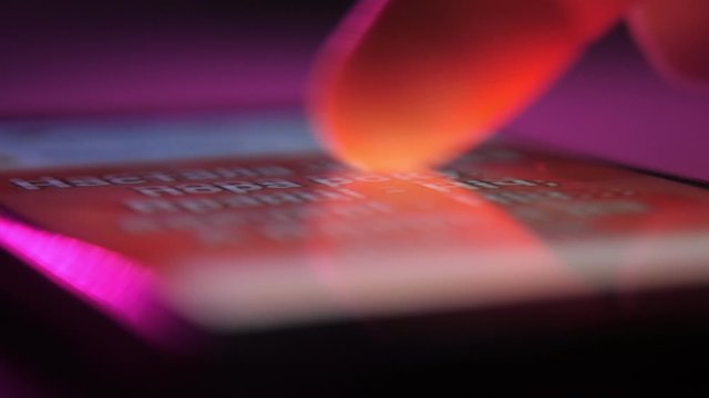 Male index touching and moving a smartphone screen with Facebook images