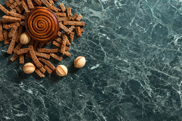 cinnamon bun, walnut cookie, rye crackers view from above marble