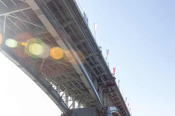 the metal bridge from the bottom of the nl with flags along the edge