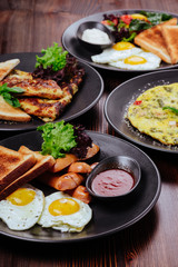 Breakfast food table. Festive brunch set, meal variety with fried egg, pancakes, croissants, smoothie ,fresh berries and fruits. Overhead view