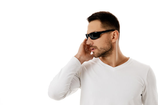 handsome bearded bodyguard or secret agent man in sunglasses on white background