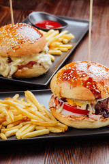 Close-up of home made burgers on wooden background