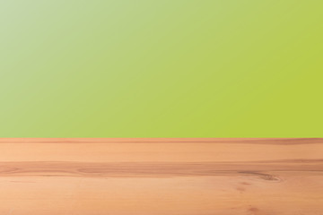 Wooden  table in front of a blurred background. Perspective brown wood with a blurry multi-colored background - can be used to showcase or assemble your products. Mock up to display the product.