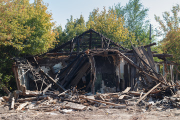 the ruins of a burned destroyed wooden house