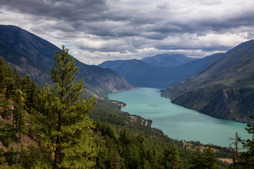 Fototapeta na wymiar Beautiful View from Above of Seton Lake surrounded by Canadian Mountain Landscape during a summer day. Taken in Shalalth near Lillooet, BC, Canada.
