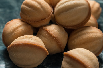 cookies walnut on green marble background close-up