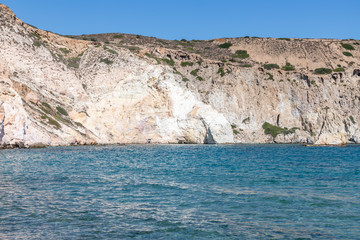 Fototapeta na wymiar Waves, cliffs, rocks and sand in Firopotamos beach
