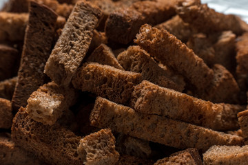 Rye crackers on green marble background close-up
