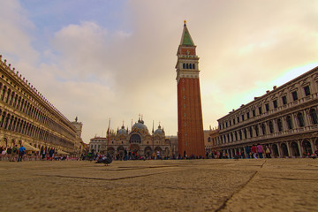 Obraz na płótnie Canvas Venice, Italy-September 28,2019:Charmin landscape of famous San Marco Square. Low perspective view. St. Mark's Basilica with tower in the background. The most visited tourist attractions in Venice