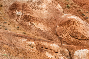 Red hills in canyon. Red colored rocks. Old bed of river in gorge