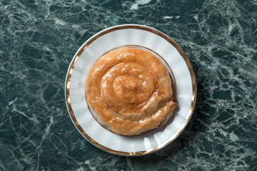 meat pie on saucer on green marble background