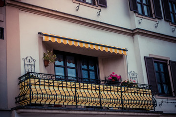 An old, beautiful balcony in a big city.