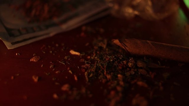 marijuana on the table, preparing to twist the jamb