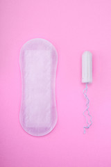 Menstrual tampon and pad on pink background 