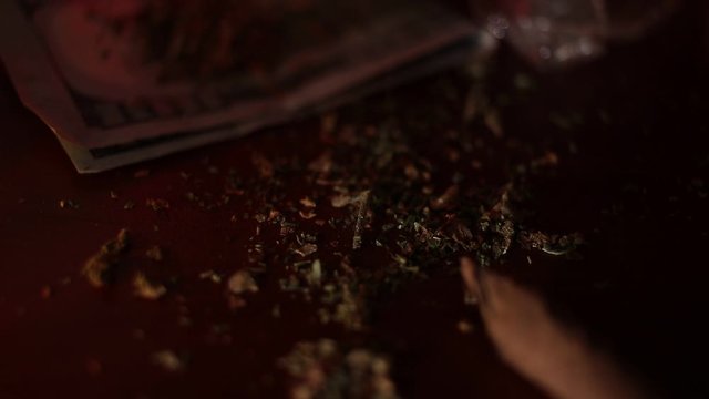 marijuana on the table, preparing to twist the jamb