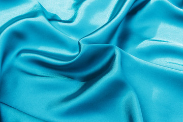 Azure blue fabric as background.  Turquoise background close up.