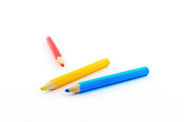 close up of colour pencils isolated on white background .