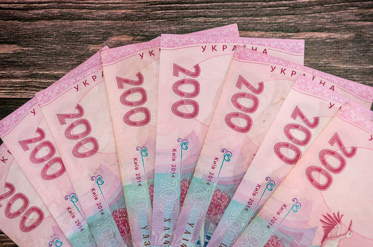 200 hryvnia on a wooden background. Ukrainian money.