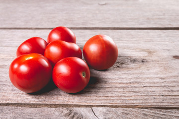 ripe tomatoes on wooden board in studio