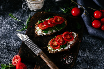Whole grain bread bruschetta with cream cheese and cherry tomatoes