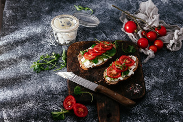 Whole grain bread bruschetta with cream cheese and cherry tomatoes