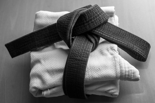 Black judo, aikido, or karate belt, tied in a knot