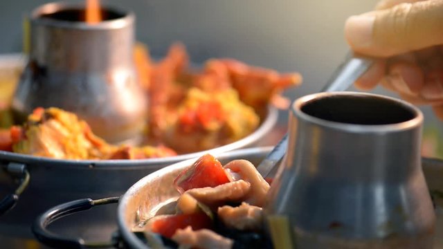 Tom Yum Kung or spicy tom yum soup with prawn - Authentic Thai style food. With ingredients: lemongrass, galangal, kaffir lime leaves, fresh chilies, and lime