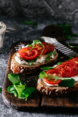 Whole grain bread bruschetta with cream cheese and cherry tomatoes