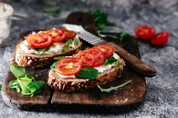 Whole grain bread bruschetta with cream cheese and cherry tomatoes