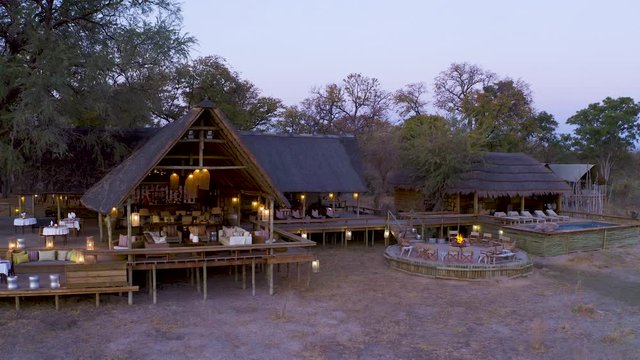 Aerial panning view of Sable Alley Safari Camp at sunset, Okavango Delta, Botswana