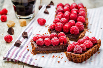 chocolate tart with chocolate filling and fresh raspberries