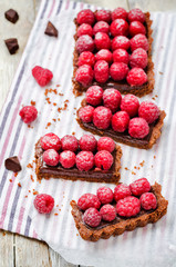 chocolate tart with chocolate filling and fresh raspberries