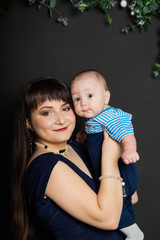 Beautiful and happy mom with a little son in the new year. Christmas meeting 2020.