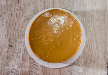 tasty cake with condensed milk on a wooden background. View from above.
