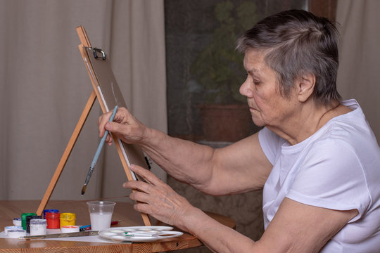 80 Year Old Woman Paints A Picture At Home. Active Old Age. Art Therapy For The Elderly