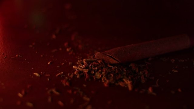 marijuana on the table, preparing to twist the jamb