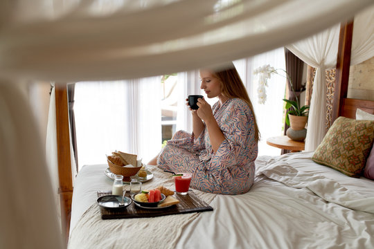 Young Woman In Bright Hotel Room Eating Healthy Vegetarian Break