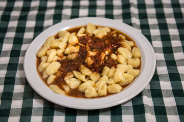 Plate of homemade gnocchi with tomato sauce
