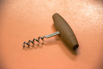 corkscrew wine opener on orange background