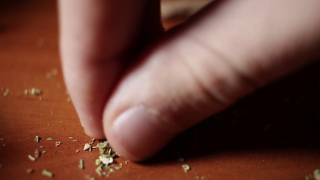 marijuana on the table, preparing to twist the jamb