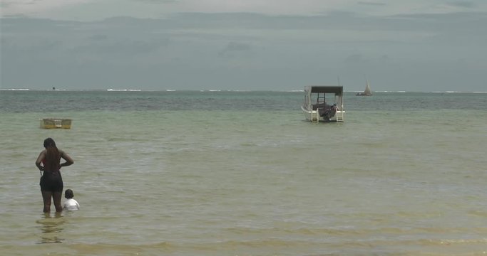 This video is about beach goers in the Indian ocean off the coast of Mombasa beach in Kenya. This video was filmed in 4k for best image quality.