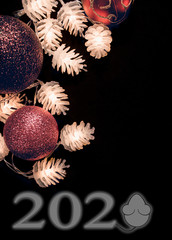 Decorative glowing pine cones with Christmas balls and lettering on black background. Congratulations on the new year 2020. The year of the white metal rat. Mouse instead of zero.