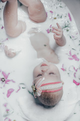 baby in milk with flowers