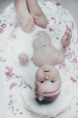 Fototapeta na wymiar baby in milk with flowers