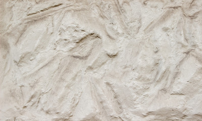 A decorative wall with a wavy structure painted in beige